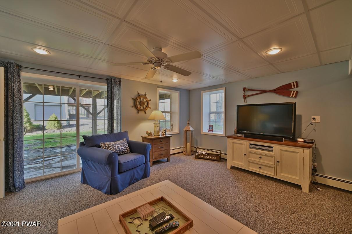 76 Rockway Road Lake Ariel, PA 18436 - Photo 69 of 101 a living room with furniture and a flat screen tv