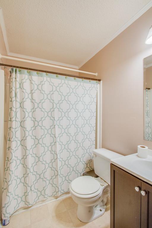 4035 Rock Springs Road Watertown, TN 37184 - Photo 14 of 26 a white toilet sitting next to a shower curtain
