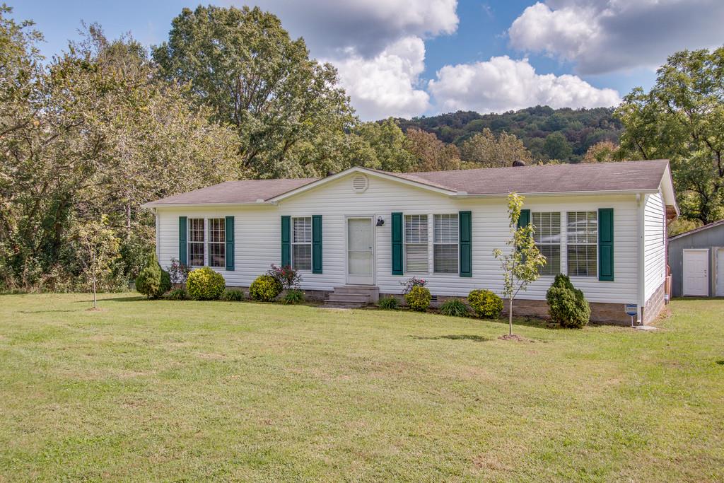 4035 Rock Springs Road Watertown, TN 37184 - Photo 3 of 26 a front view of a house with a garden and porch
