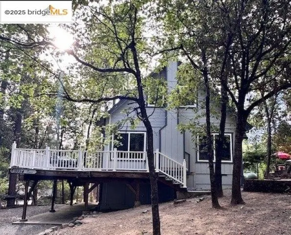 a view of a large with large trees and a barn