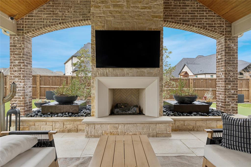 582 Broadleaf Way Haslet, TX 76052 - Photo 34 of 40 Arched openings on either side of the fireplace offer natural light, water and fire features. Serene area for relaxing and enjoying beautiful Texas sunsets!