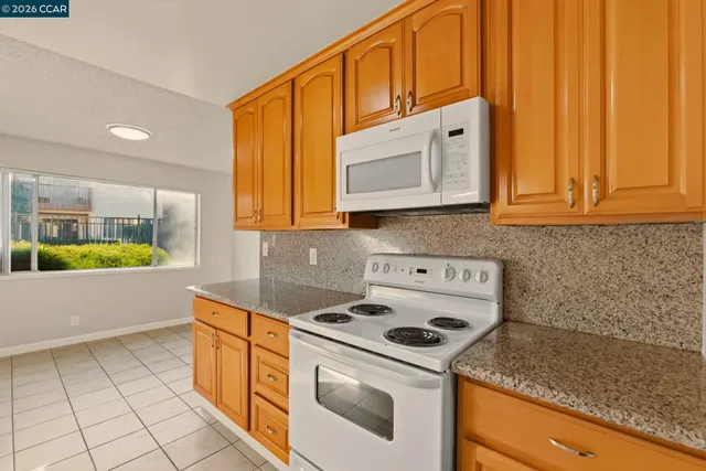 a kitchen with a sink a stove and cabinets