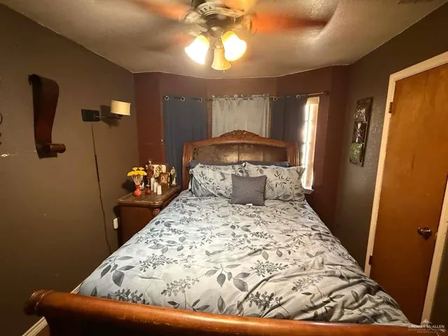 a bed sitting in a bedroom next to a window