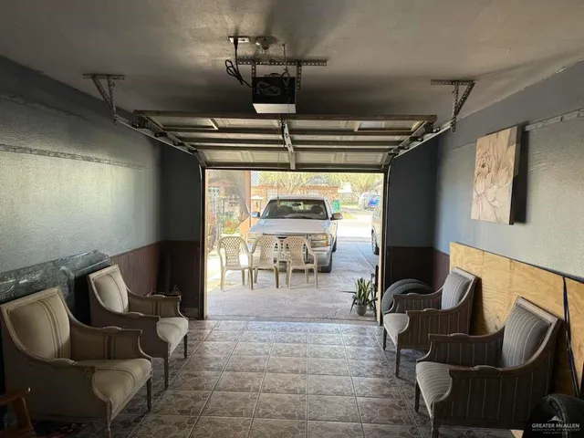 a dining room with furniture and a chandelier