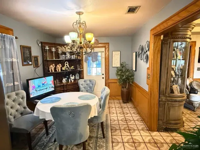 a view of a dining room with furniture and chandelier
