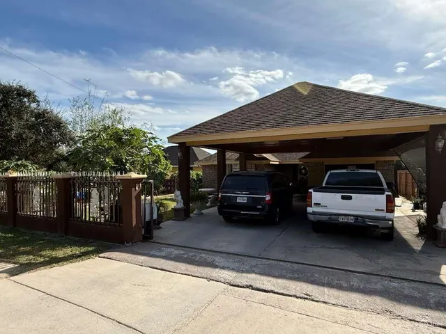 a view of a car parked front of a house