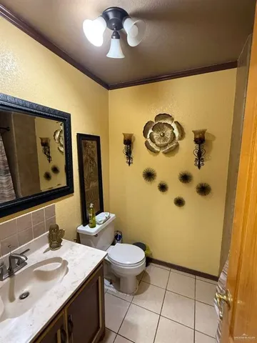 a bathroom with a granite countertop sink mirror vanity and toilet