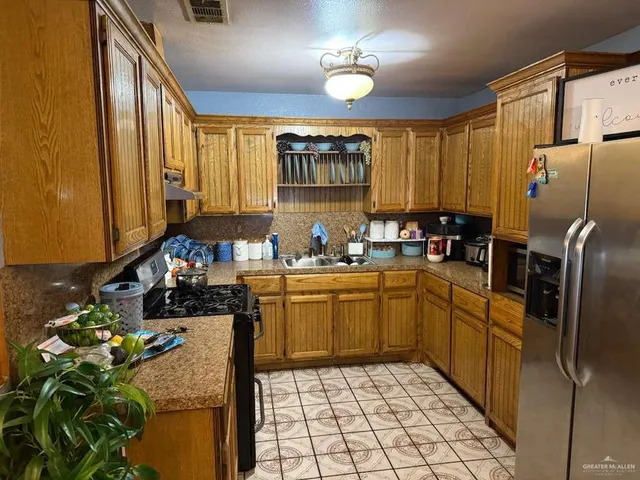 a kitchen with refrigerator and cabinets