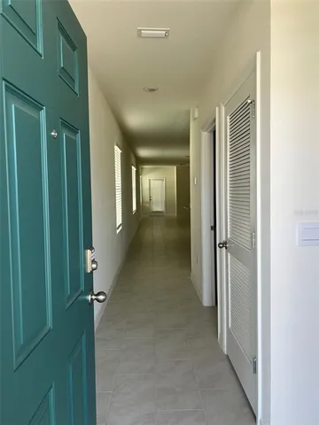 a view of a hallway with wooden shelves