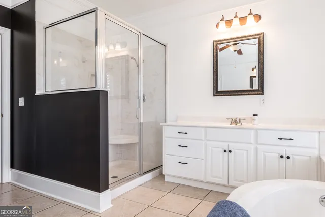 a bathroom with a double vanity sink mirror and shower