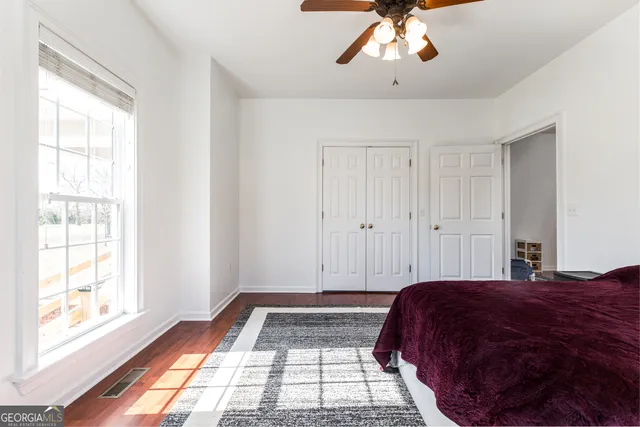 a bedroom with a bed and a window