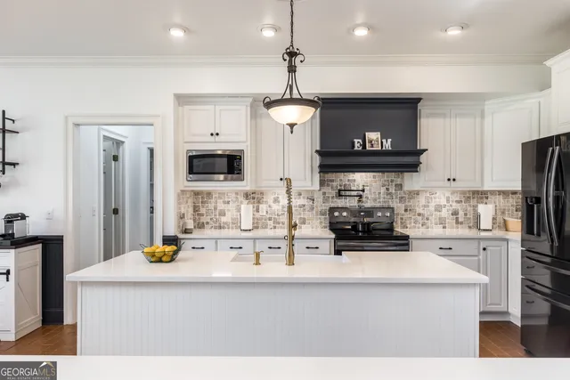 a kitchen with stainless steel appliances a stove sink and microwave