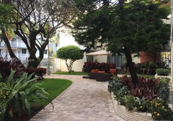 a view of a house with a sitting area and garden