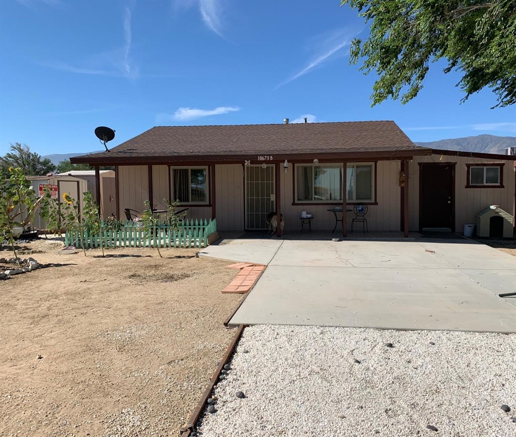 10673 Godwin Road Lucerne Valley, CA 92356 - Photo 1 of 1 a front view of a house with a yard and a garage