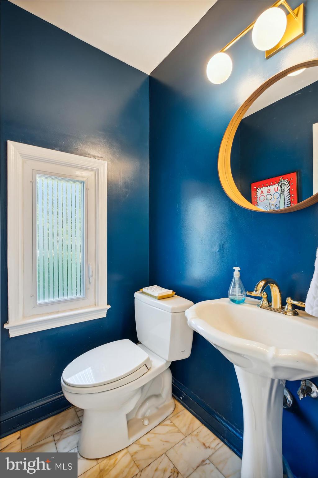 7304 Radnor Road Bethesda, MD 20817 - Photo 25 of 55 a bathroom with a toilet a sink and mirror