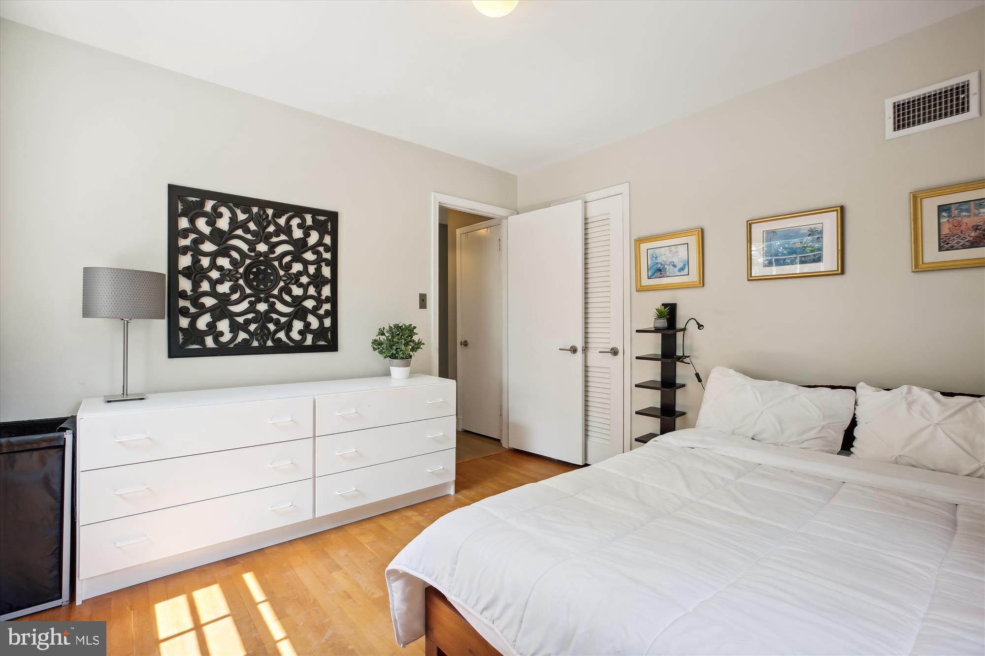 7304 Radnor Road Bethesda, MD 20817 - Photo 32 of 55 a bedroom with a bed and a painting on the wall
