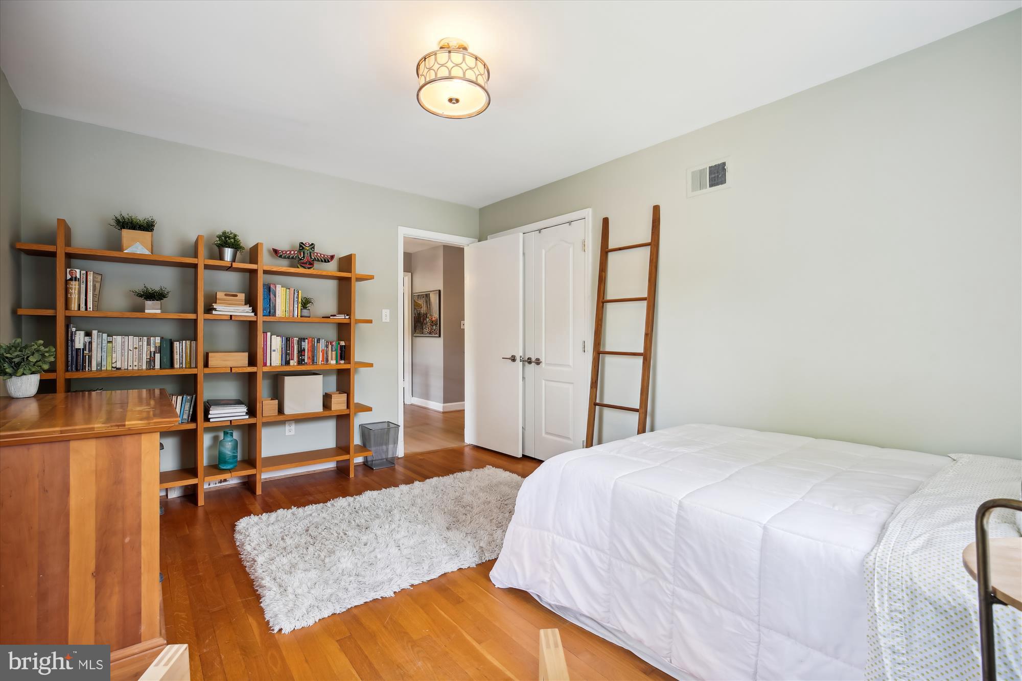 7304 Radnor Road Bethesda, MD 20817 - Photo 35 of 55 a bedroom with a bed and a book shelf