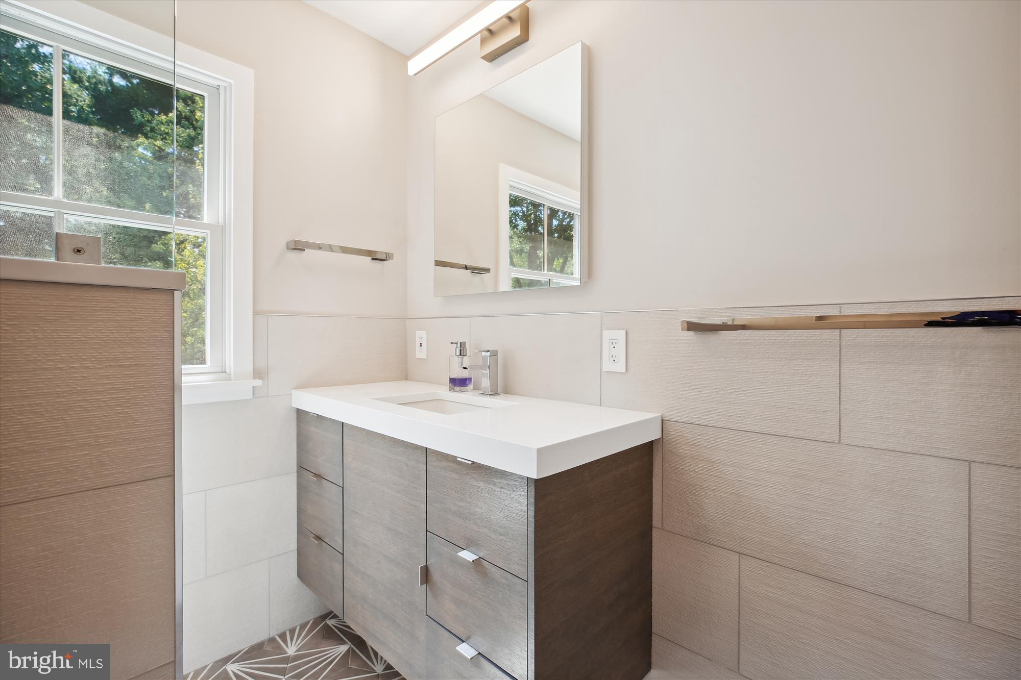 7304 Radnor Road Bethesda, MD 20817 - Photo 40 of 55 a bathroom with a sink vanity and a mirror