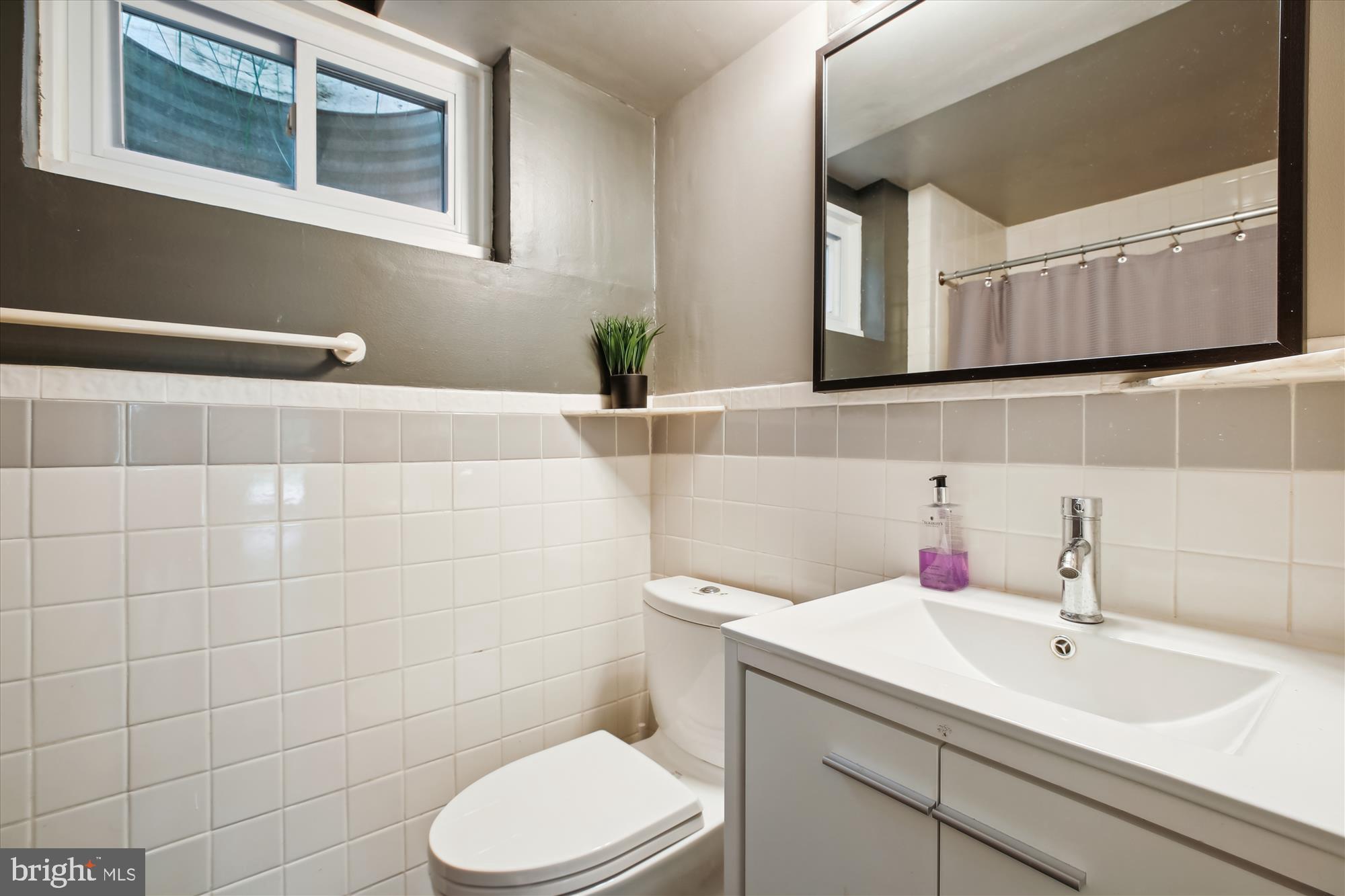 7304 Radnor Road Bethesda, MD 20817 - Photo 47 of 55 a bathroom with a sink toilet and mirror