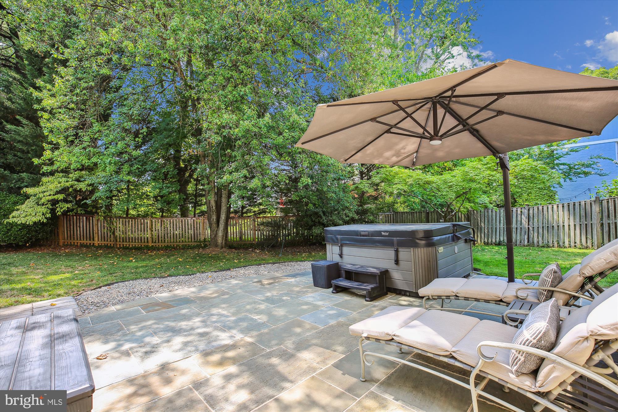 7304 Radnor Road Bethesda, MD 20817 - Photo 52 of 55 a view of backyard with table and chairs under an umbrella