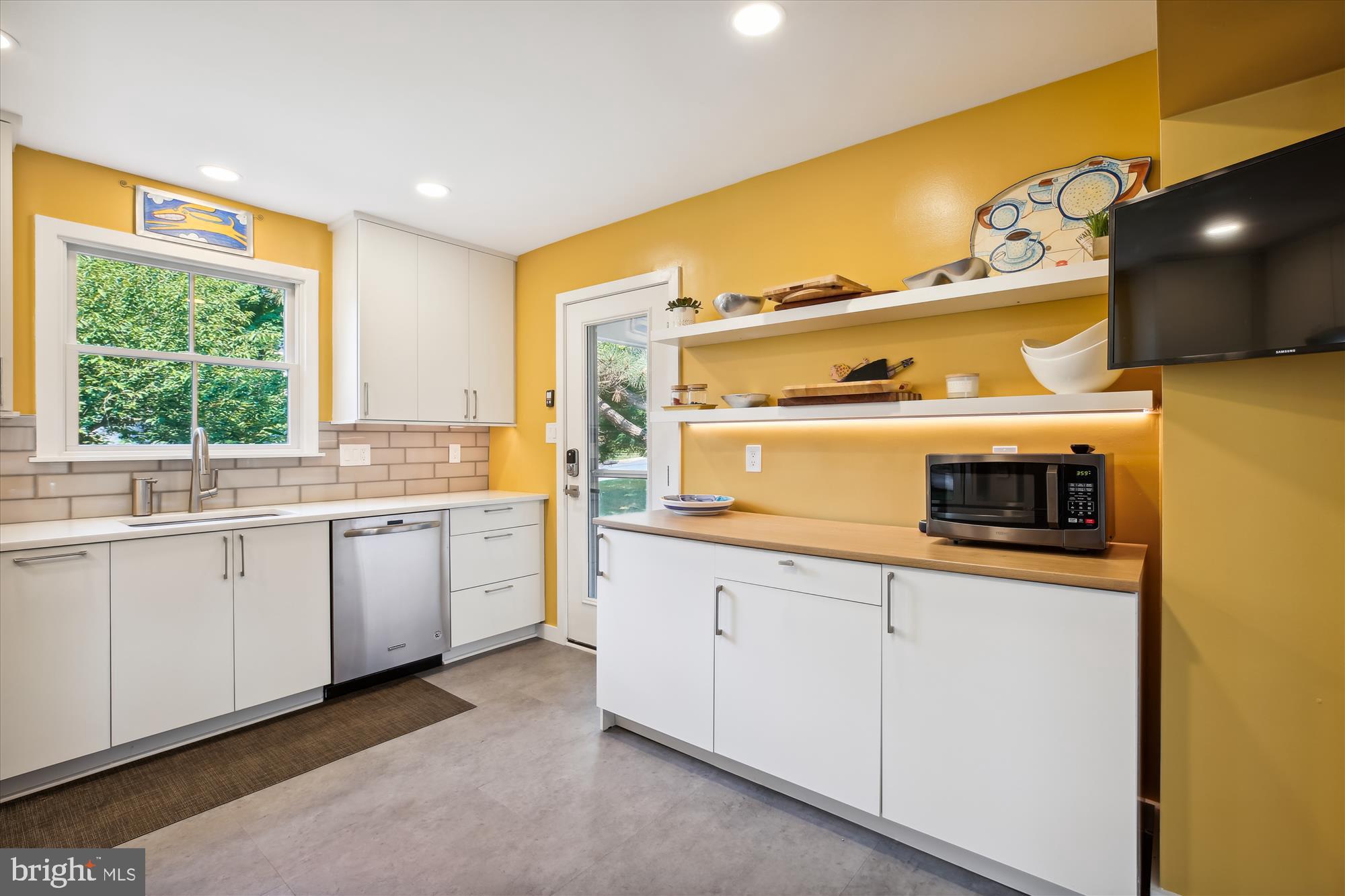 7304 Radnor Road Bethesda, MD 20817 - Photo 7 of 55 a kitchen with stainless steel appliances a sink and cabinets