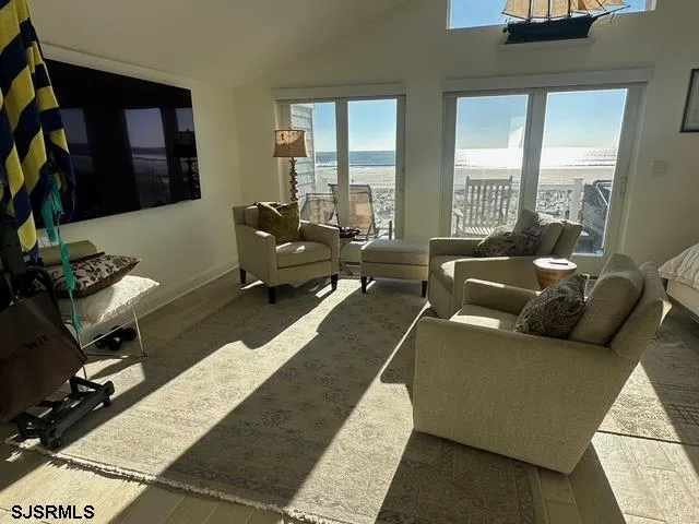 a living room with furniture and large windows