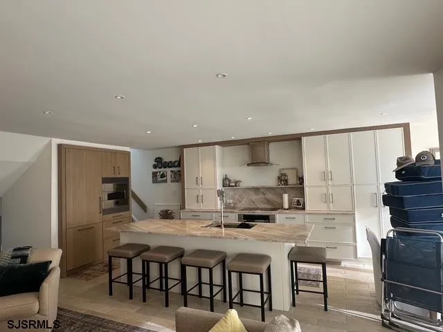 a kitchen with a table chairs refrigerator and cabinets