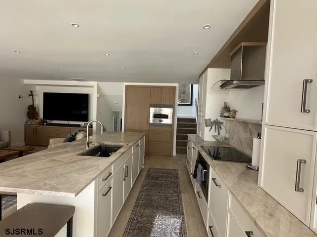 a kitchen with stainless steel appliances a sink and a stove