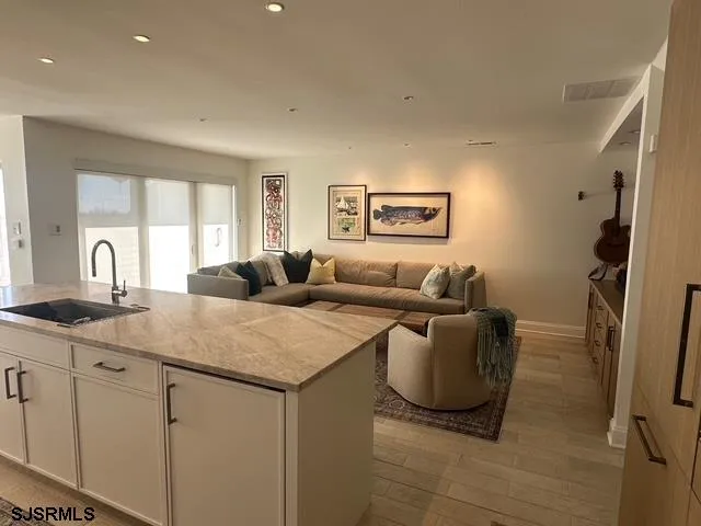 a living room with hard wood floors and a sink