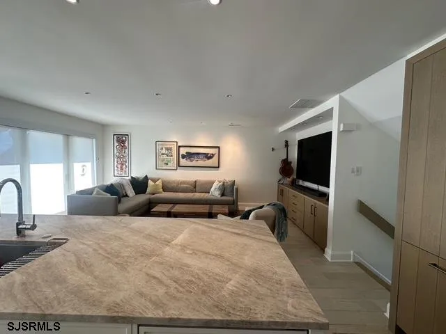 a large bedroom with a bed and a flat screen tv