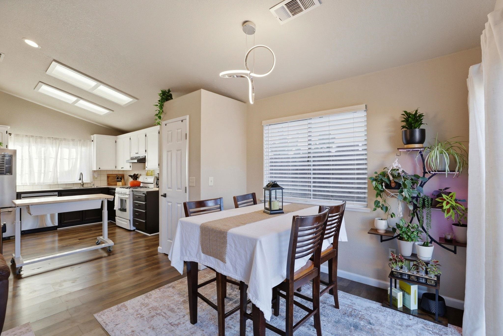 799 Morgans Ranch Circle Galt, CA 95632 - Photo 15 of 36 Dining room featuring lofted ceiling and dark wood-style flooring