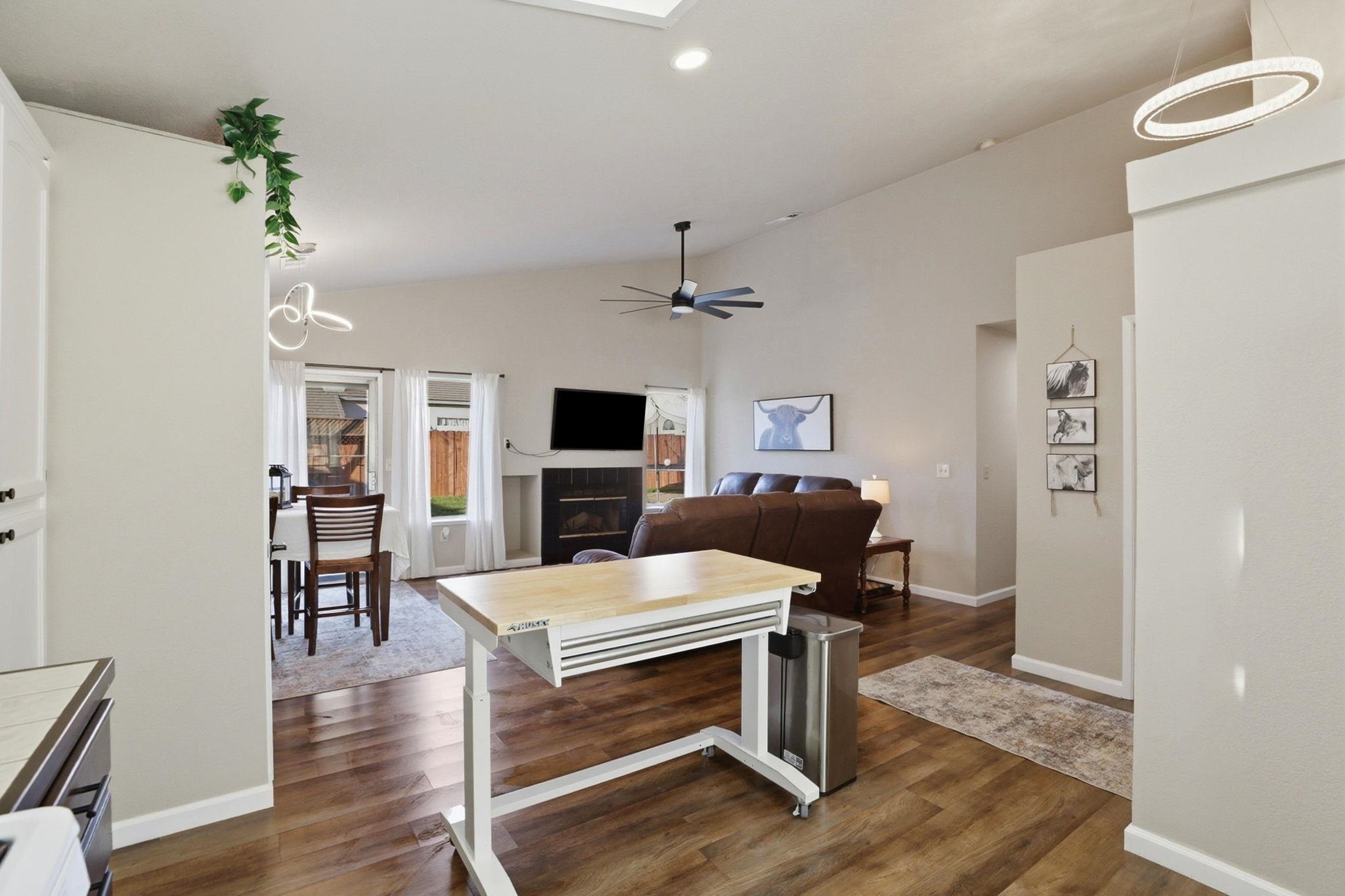 799 Morgans Ranch Circle Galt, CA 95632 - Photo 16 of 36 Living room featuring lofted ceiling, dark wood-type flooring, recessed lighting, ceiling fan, and a glass covered fireplace