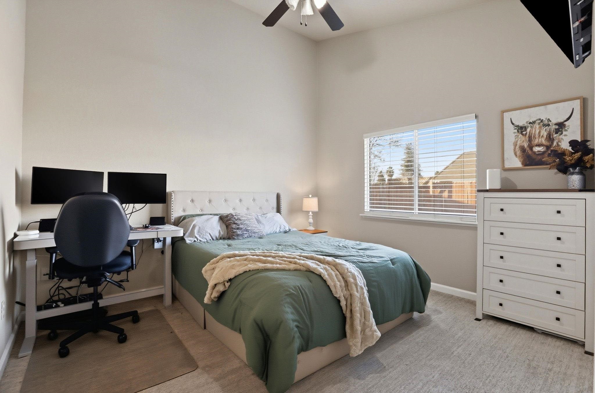 799 Morgans Ranch Circle Galt, CA 95632 - Photo 17 of 36 Bedroom with a desk, light colored carpet, and ceiling fan