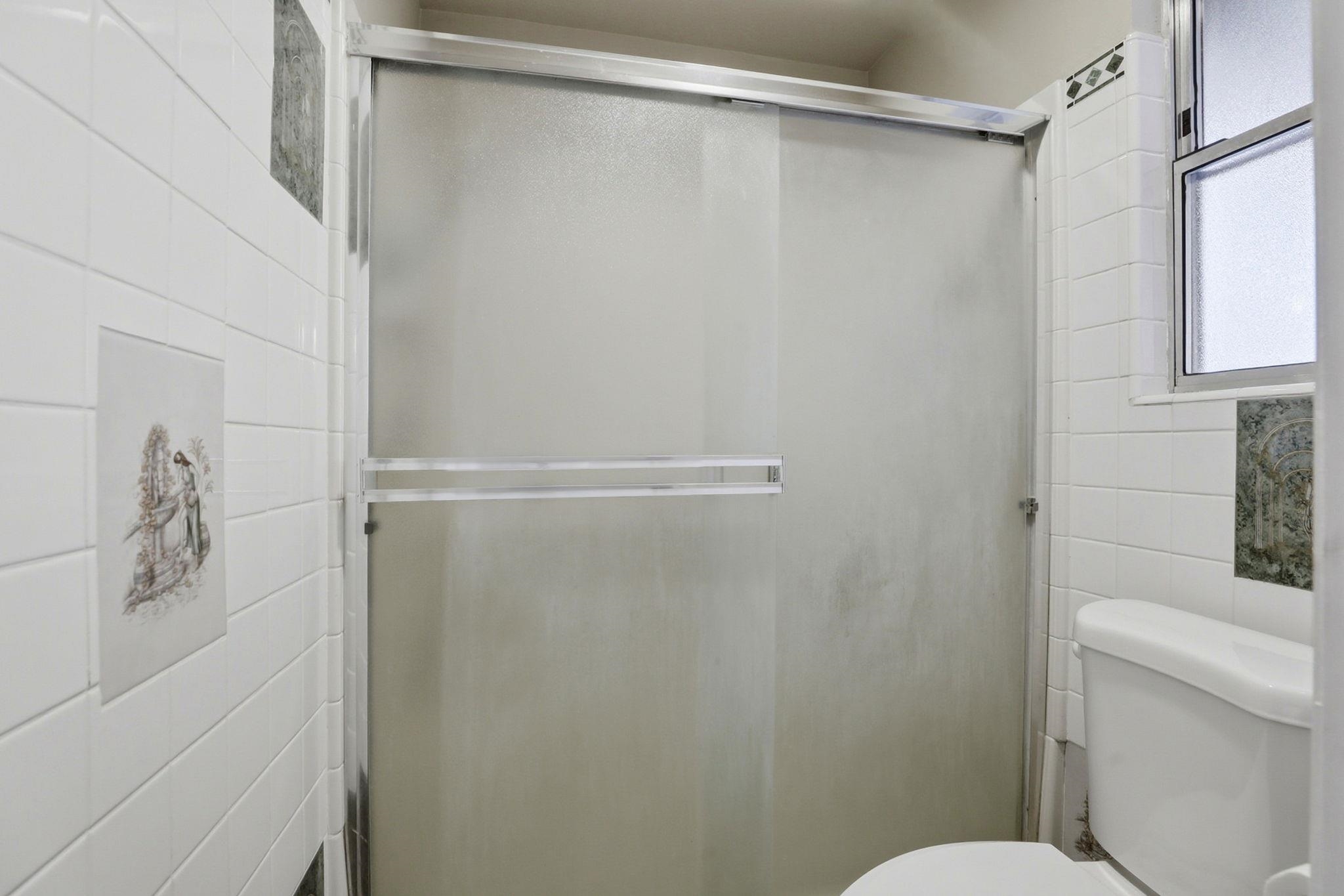 799 Morgans Ranch Circle Galt, CA 95632 - Photo 28 of 36 Full bathroom featuring a shower stall and tile walls