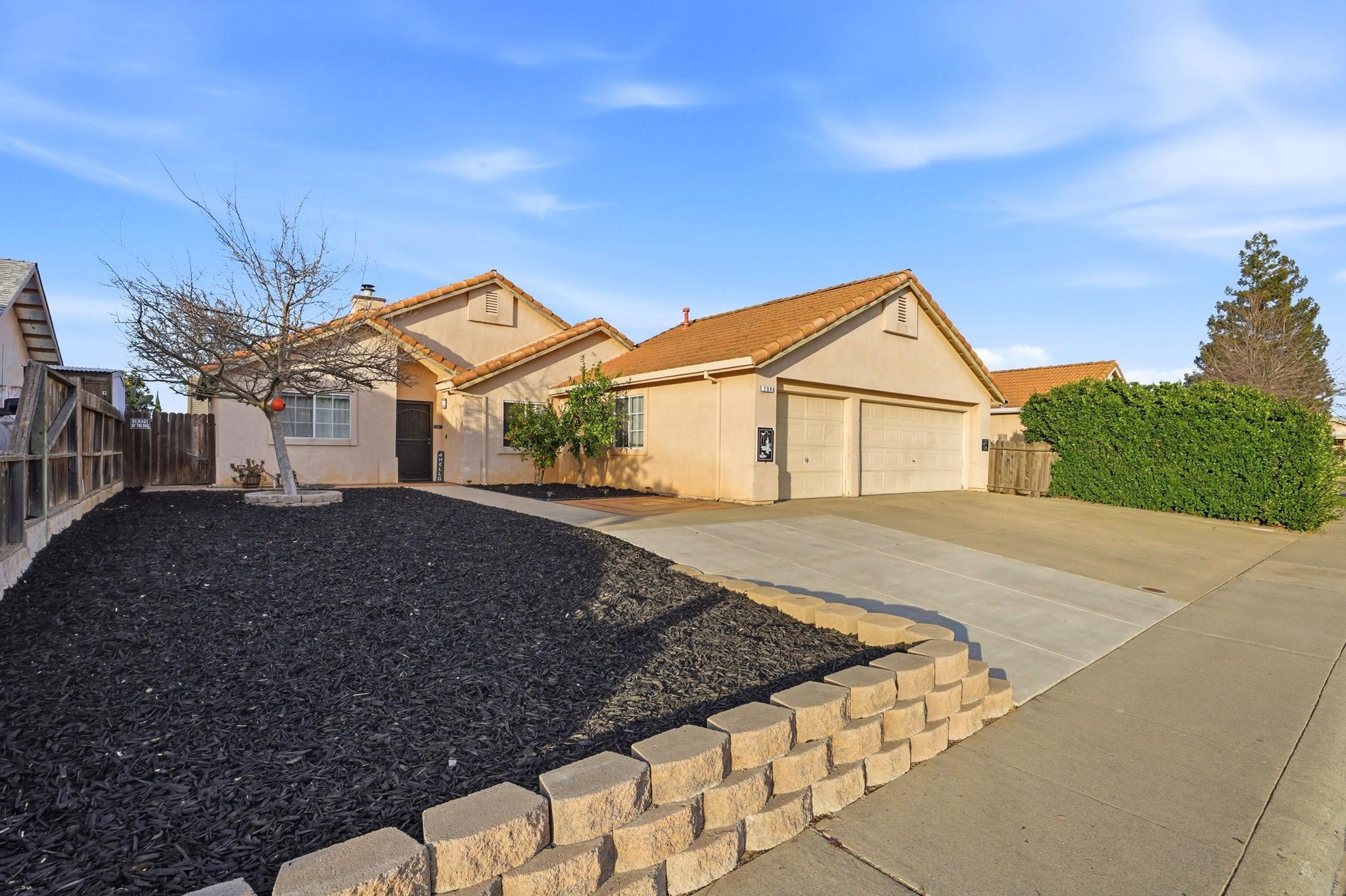 799 Morgans Ranch Circle Galt, CA 95632 - Photo 3 of 36 View of front of home featuring stucco siding, concrete driveway, a garage, a tiled roof, and a chimney