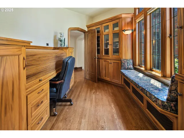 a very nice looking room with many windows and furniture