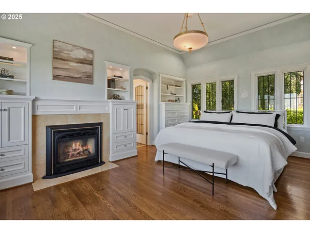 a bedroom with a bed and a fireplace