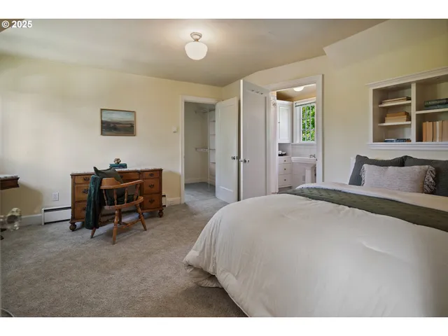 a bedroom with a bed and a desk