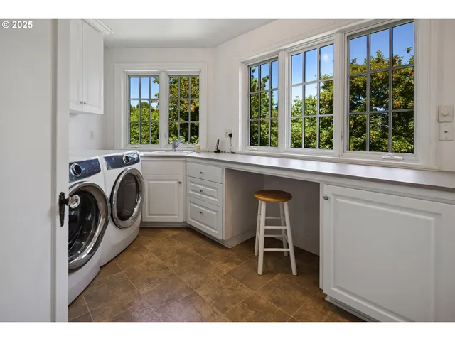 a utility room with a sink dryer and washer