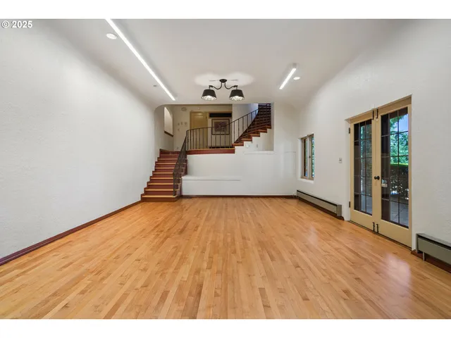 a view of a room with wooden floor and stairs