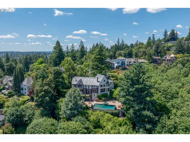a view of a house with a yard and trees