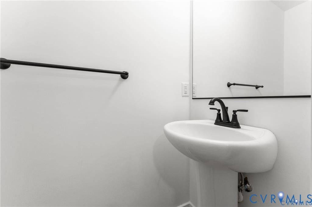 302 Musket Drive Ruther Glen, VA 22546 - Photo 12 of 27 a bathroom with a sink and mirror