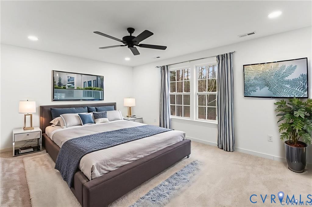 302 Musket Drive Ruther Glen, VA 22546 - Photo 13 of 27 a spacious bedroom with a bed and a potted plant