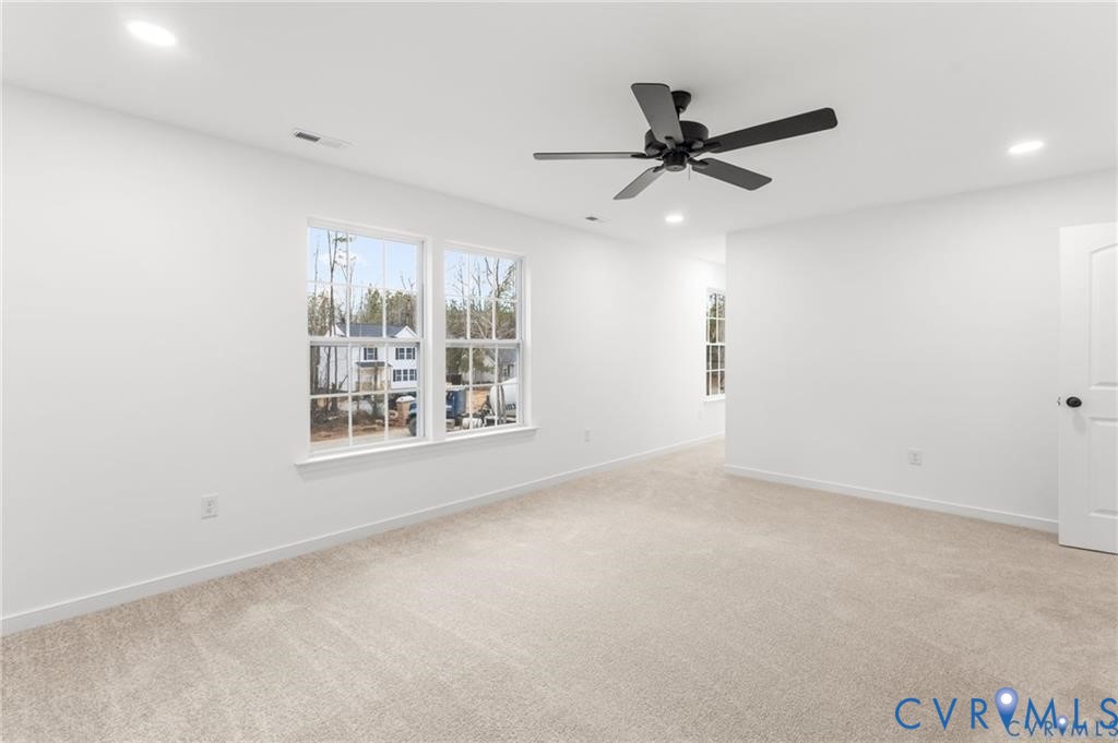 302 Musket Drive Ruther Glen, VA 22546 - Photo 15 of 27 an empty room with windows and fan