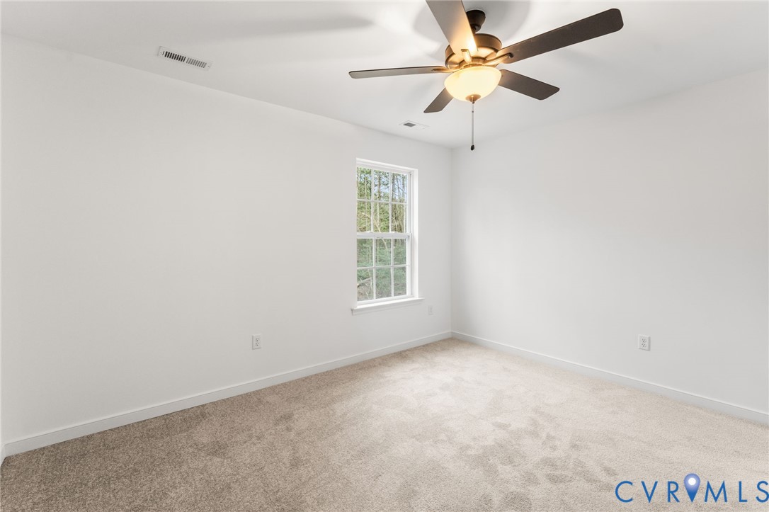 302 Musket Drive Ruther Glen, VA 22546 - Photo 21 of 27 an empty room with a window and a fan