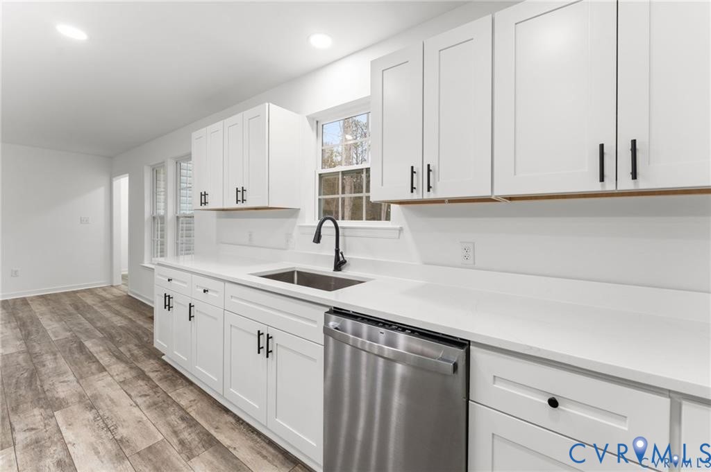 302 Musket Drive Ruther Glen, VA 22546 - Photo 9 of 27 a kitchen with white cabinets and a sink
