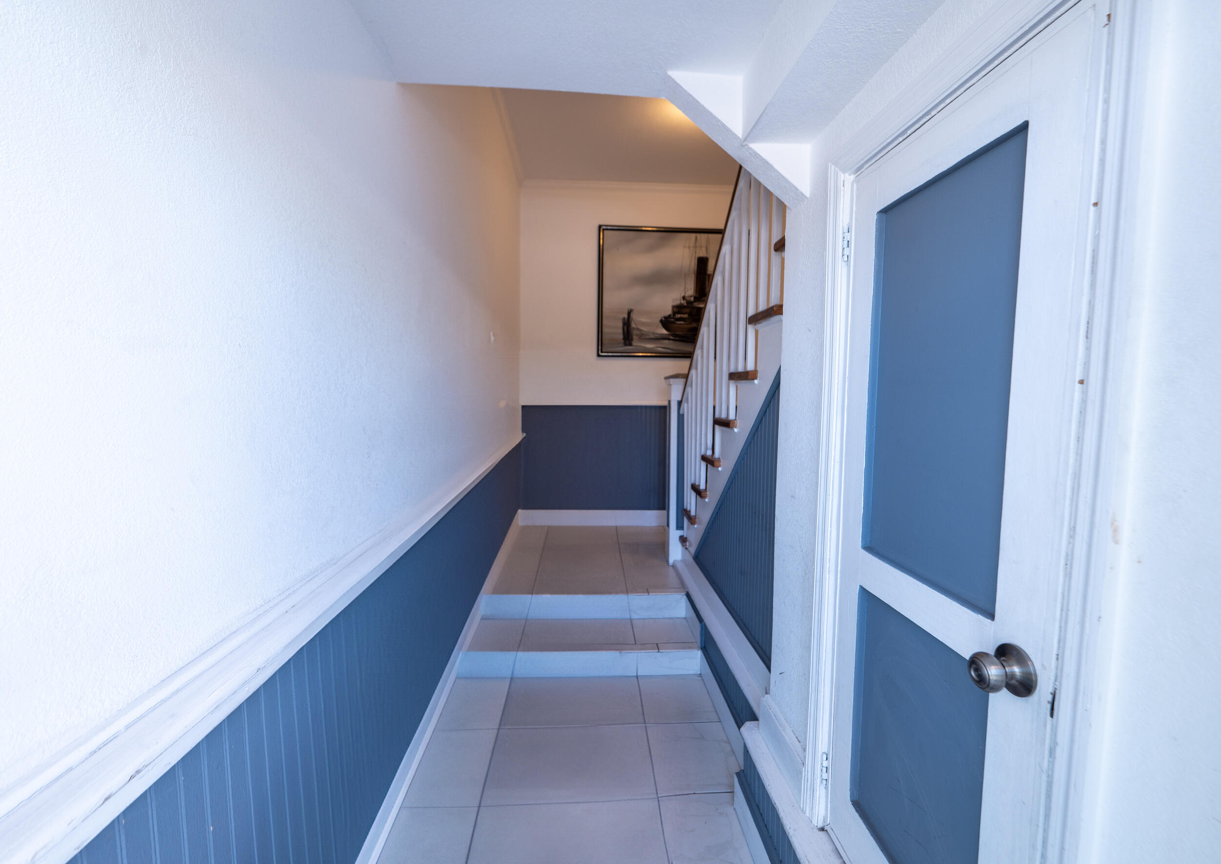 a view of a hallway with wooden floor and staircase