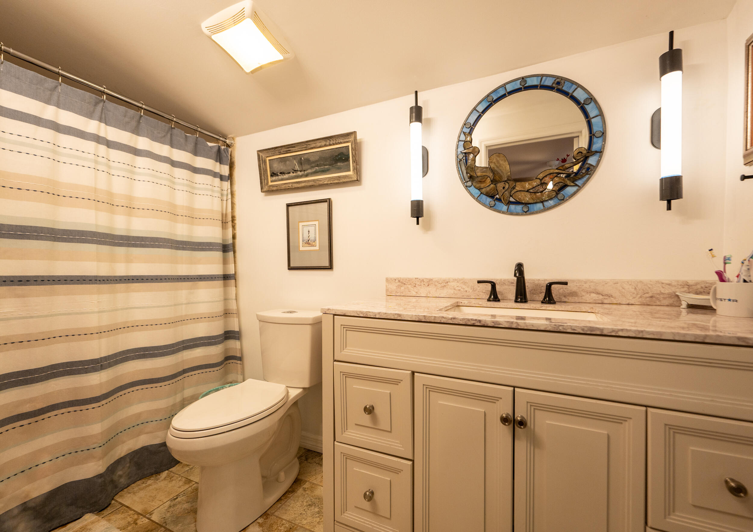 1124 Catherine Street, Unit 202 Key West, FL 33040 - Photo 15 of 22 a bathroom with a granite countertop toilet sink and mirror