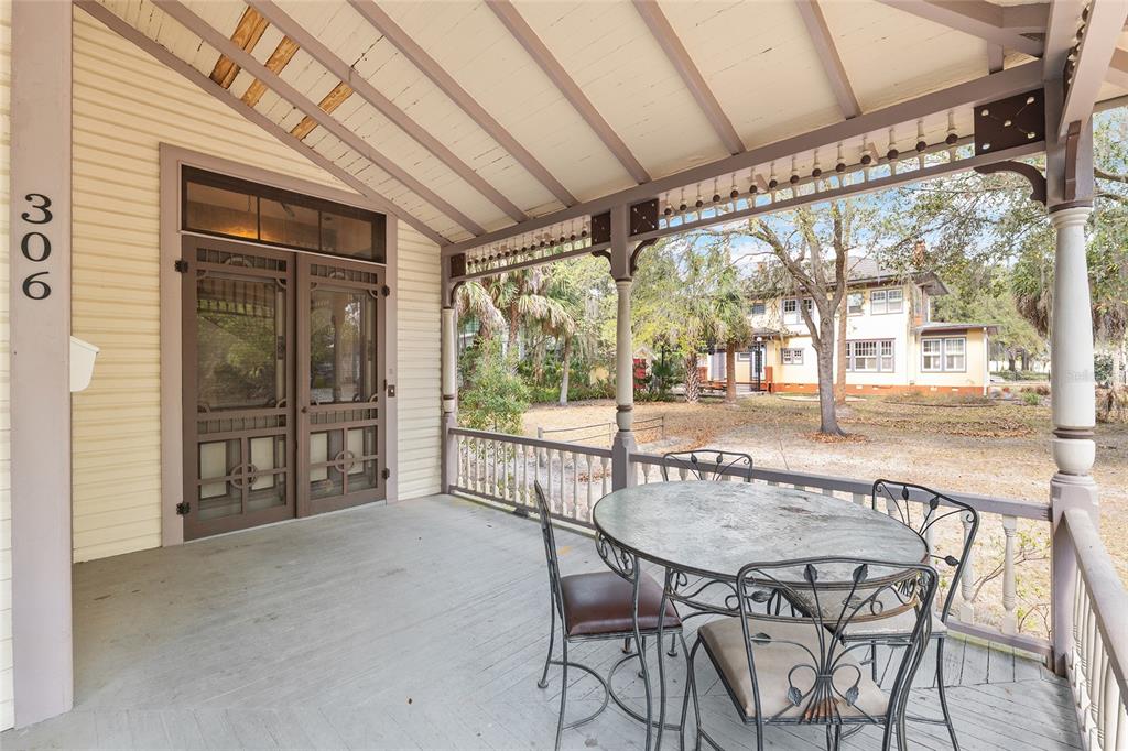 306 Northeast 3rd Street Gainesville, FL 32601 - Photo 11 of 88 a view of a patio with a table and chairs and couches with wooden floor
