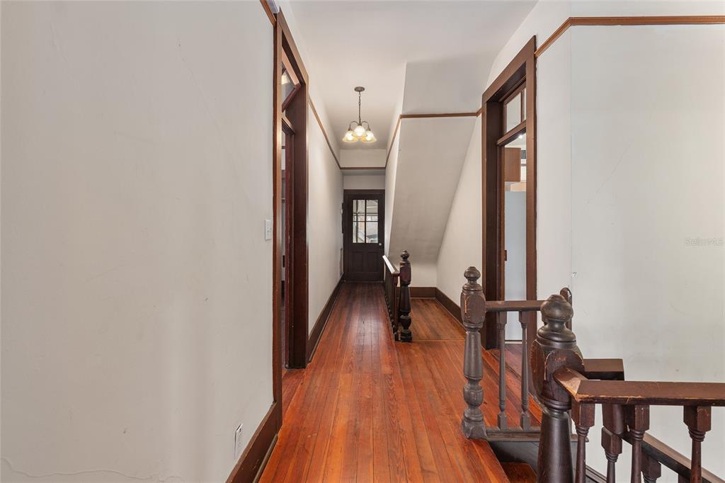 306 Northeast 3rd Street Gainesville, FL 32601 - Photo 21 of 88 a view of a hallway with wooden floor and staircase